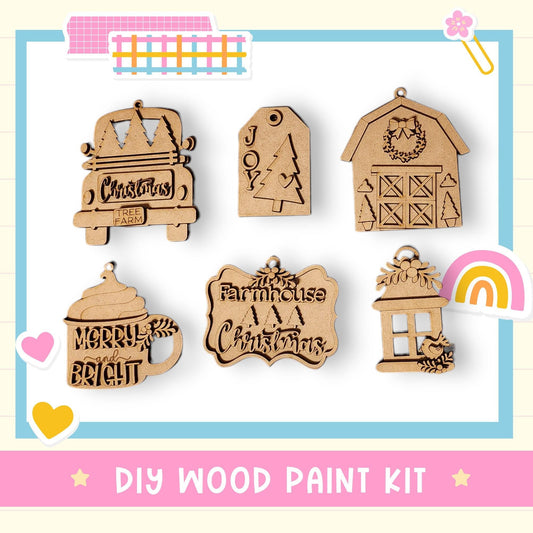 a DIY wood paint kit with various wooden ornaments and decorations, including a Christmas tree, a barn, a house, a mug, and a birdhouse.