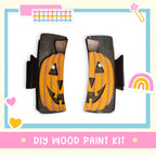a DIY wood paint kit with two carved pumpkin-shaped pieces, one on each side, set against a white background.