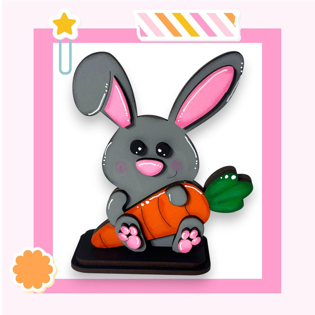 a picture of a bunny holding a carrot
