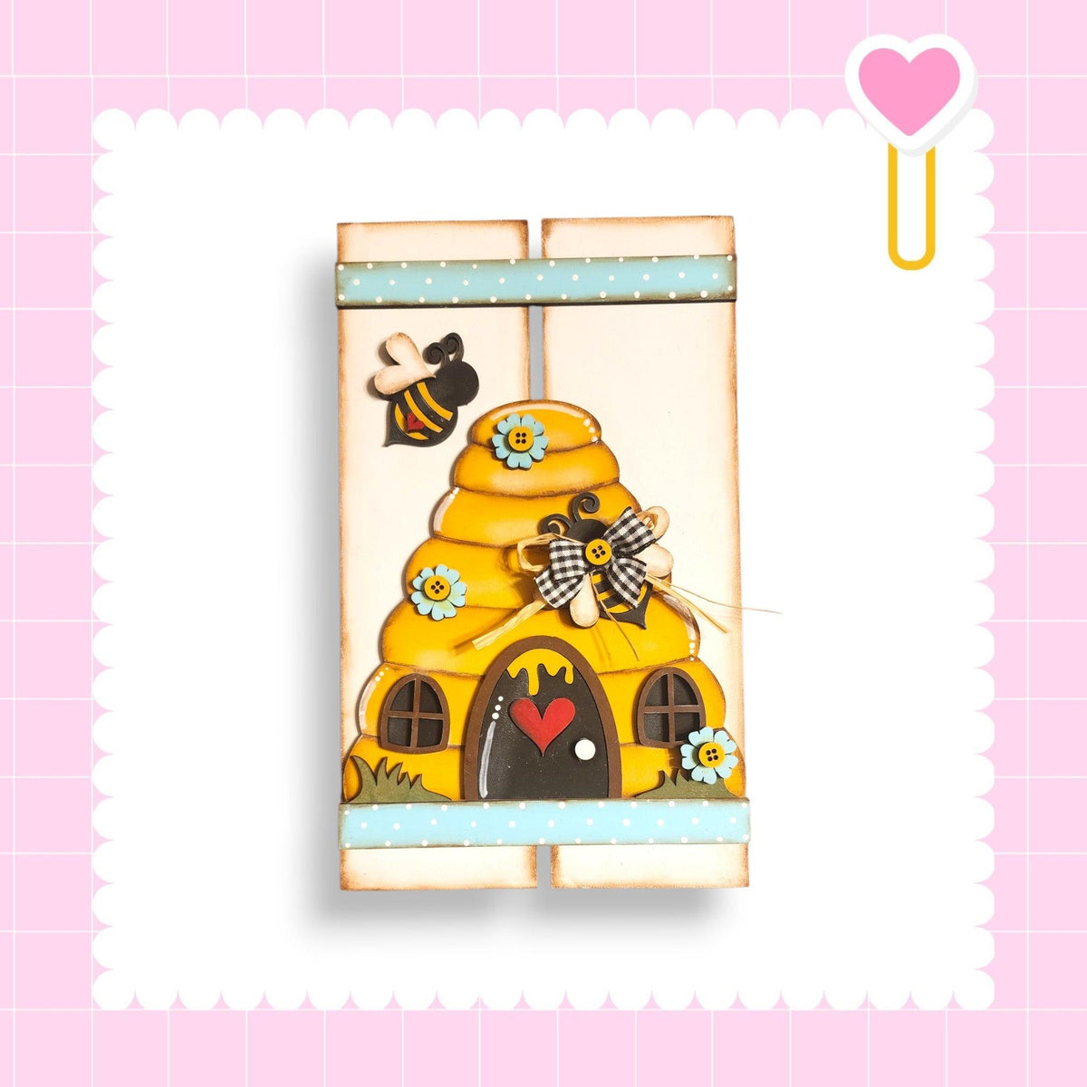 a picture of a yellow house with a bee on it