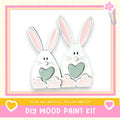 two cute white rabbits with hearts on their paws, set against a pink and yellow background.