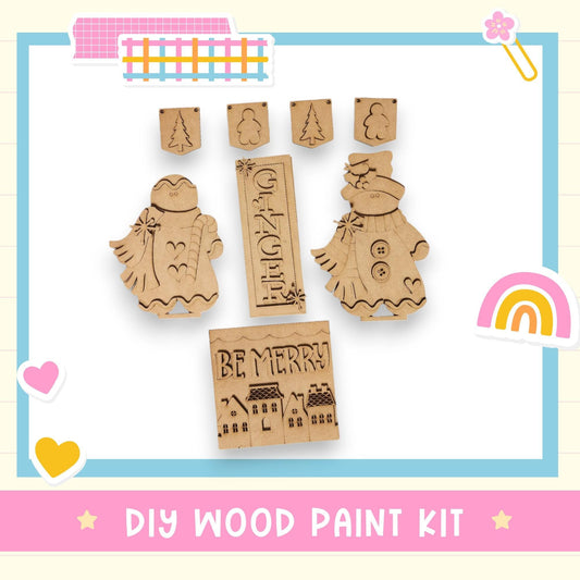 The image is a DIY wood paint kit featuring various wooden shapes and designs, including a gingerbread man, a sign that says "GINGER", and a "BE MERRY" sign. The kit appears to be a creative and fun project for woodworking enthusiasts.