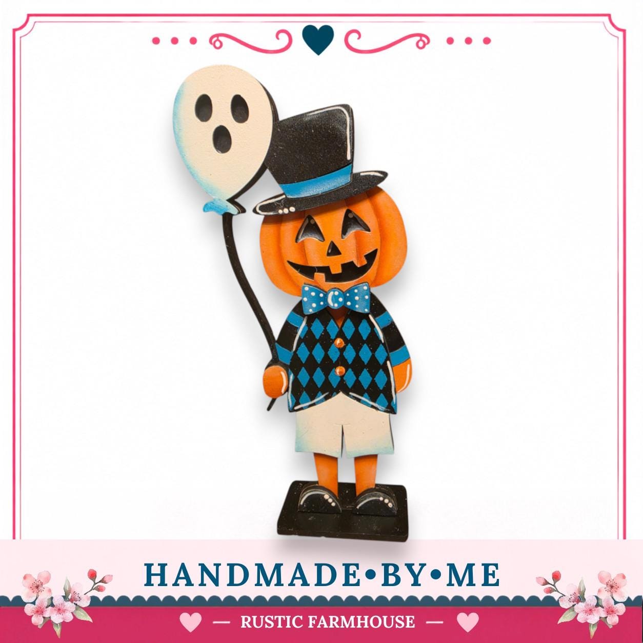 A hand-made wooden pumpkin figure wearing a top hat and holding a balloon, with a floral border around the edges.