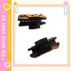 two wooden clamps, one black and one brown, with a pink and yellow border.