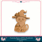 A wooden cat wearing a witch's hat and carrying a carved pumpkin, set against a white background with a decorative border.