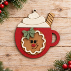 A wooden ornament in the shape of a cup with a gingerbread man figure inside, surrounded by Christmas decorations.