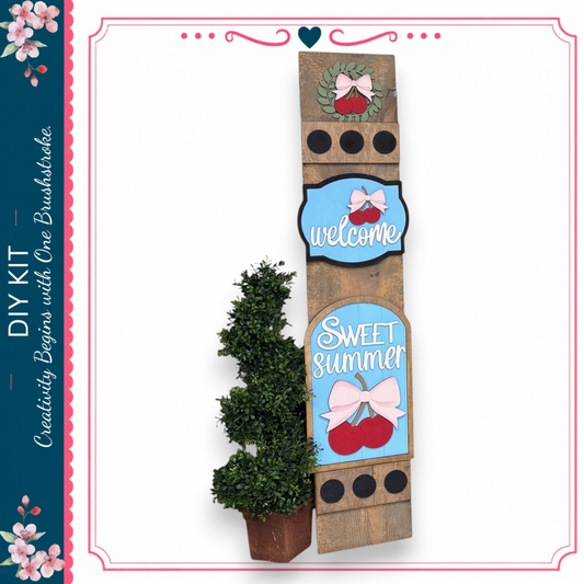 a DIY kit for creating a wooden sign with decorative elements, including a potted plant and a wreath.