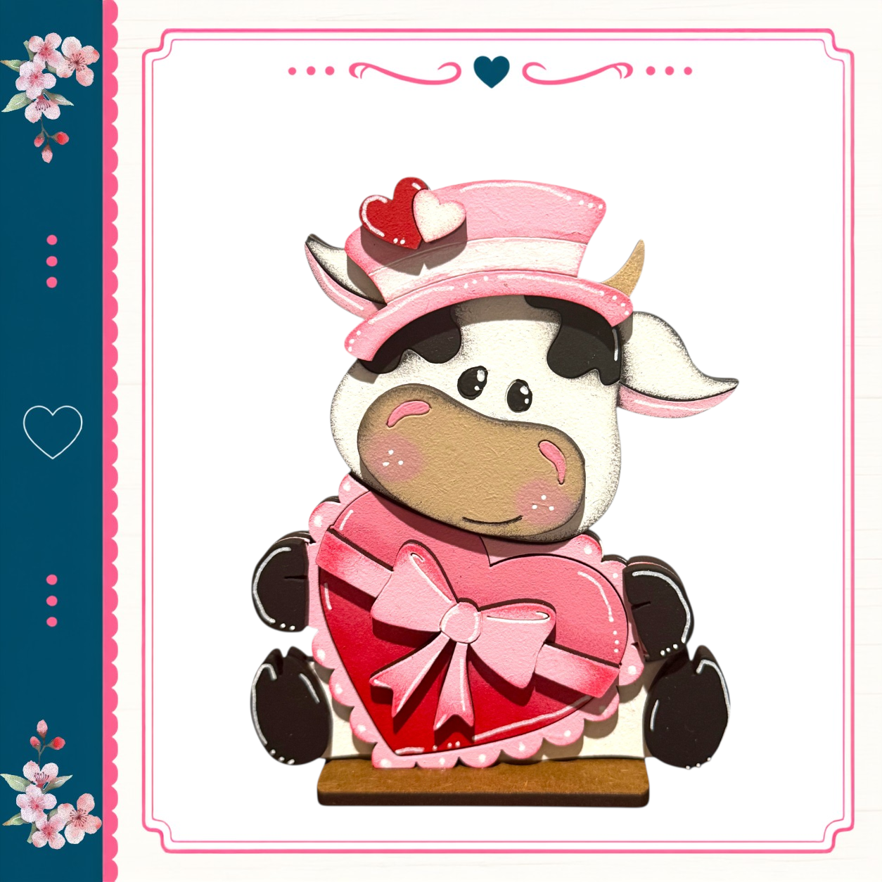 A cartoon cow wearing a pink hat and a pink heart-shaped bow, sitting on a wooden surface.