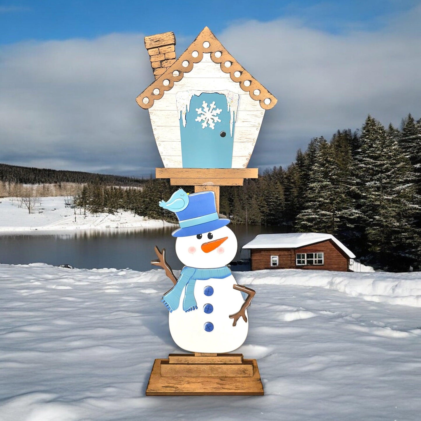 a snowman is standing in front of a birdhouse