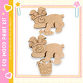 two wooden cutouts of rabbits, one holding a basket of carrots, set against a pink and yellow background with decorative elements.