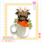 A whimsical image featuring a cartoon rabbit or deer-like creature with large ears and a carrot, peeking out from a white mug or cup.