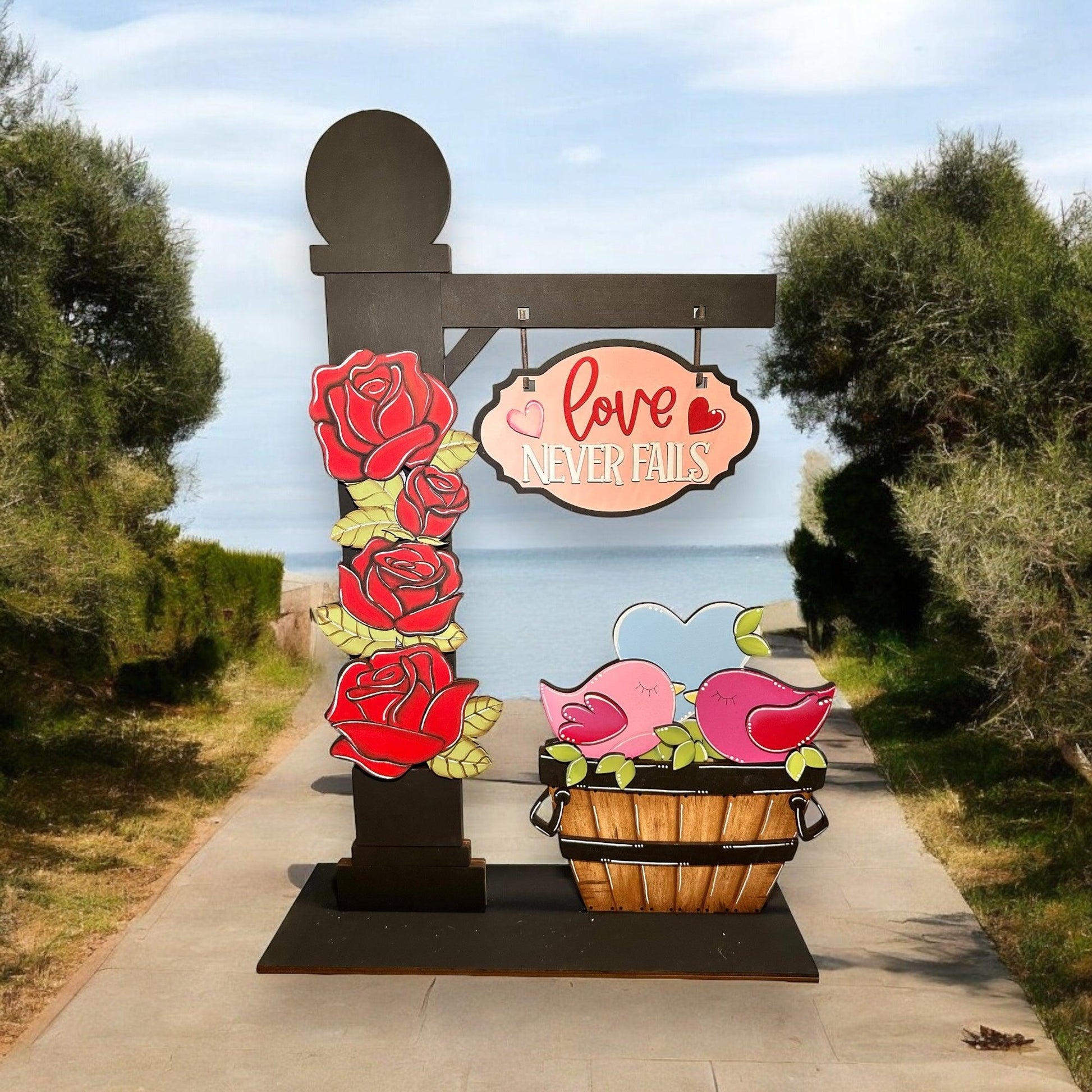 a sign with a basket of flowers in front of it