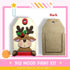 a DIY wood paint kit for creating a wooden ornament with a reindeer design. The kit includes a wooden tag with a reindeer and a wooden frame, as well as a wooden card with a reindeer design. The kit is designed to be used by those who can create the ornament themselves.