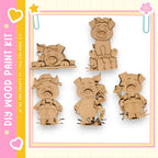 five wooden pig figurines, each with different poses and expressions, arranged in a row against a white background.