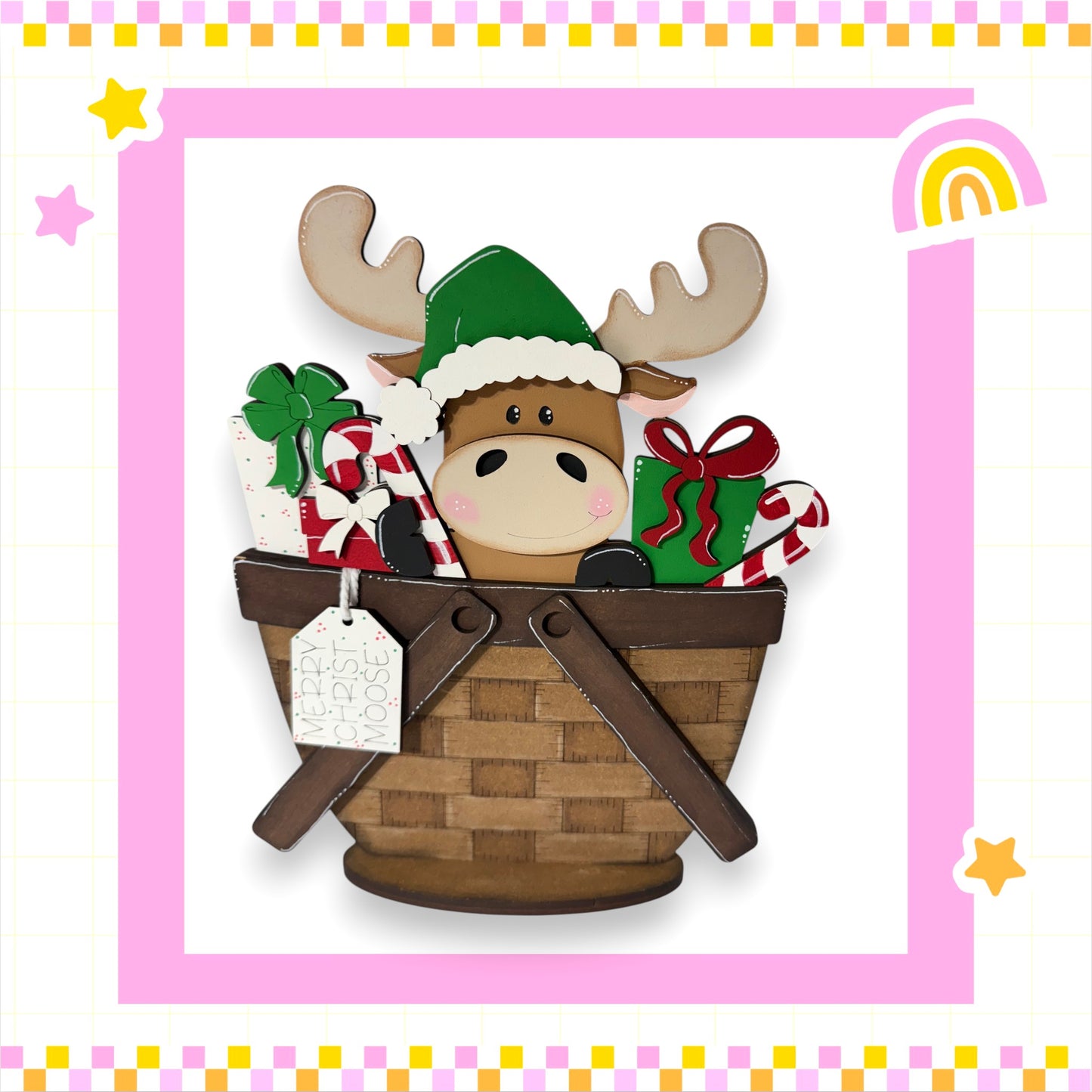 A wooden moose wearing a Santa hat is sitting in a brown wicker basket filled with Christmas gifts, including presents and candy canes.