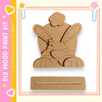 a wooden paint kit with a cute bunny design, including a wooden frame and a wooden stick.
