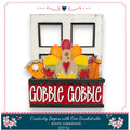 A Thanksgiving-themed DIY kit featuring a wooden frame with a turkey decoration, a pumpkin, and other fall-themed elements. The kit is labeled as "Creativity Begins with One Brushstroke - Rustic Farmhouse - DIY Kit".