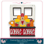 A Thanksgiving-themed DIY kit featuring a wooden frame with a turkey decoration, a pumpkin, and other fall-themed elements. The kit is labeled as "Creativity Begins with One Brushstroke - Rustic Farmhouse - DIY Kit".