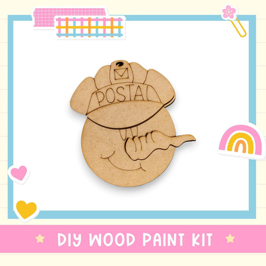 a DIY wood paint kit with a wooden postcard-shaped object that has the word "POSTAL" written on it. The kit appears to be a creative and fun craft project for children.