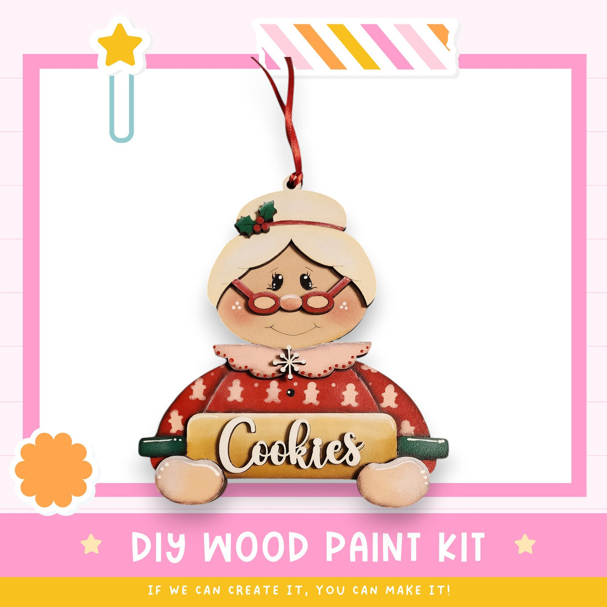 A wooden ornament in the shape of a woman holding a cookie sheet, with the word "Cookies" written on it. The ornament is hanging from a string and is part of a DIY wood paint kit.