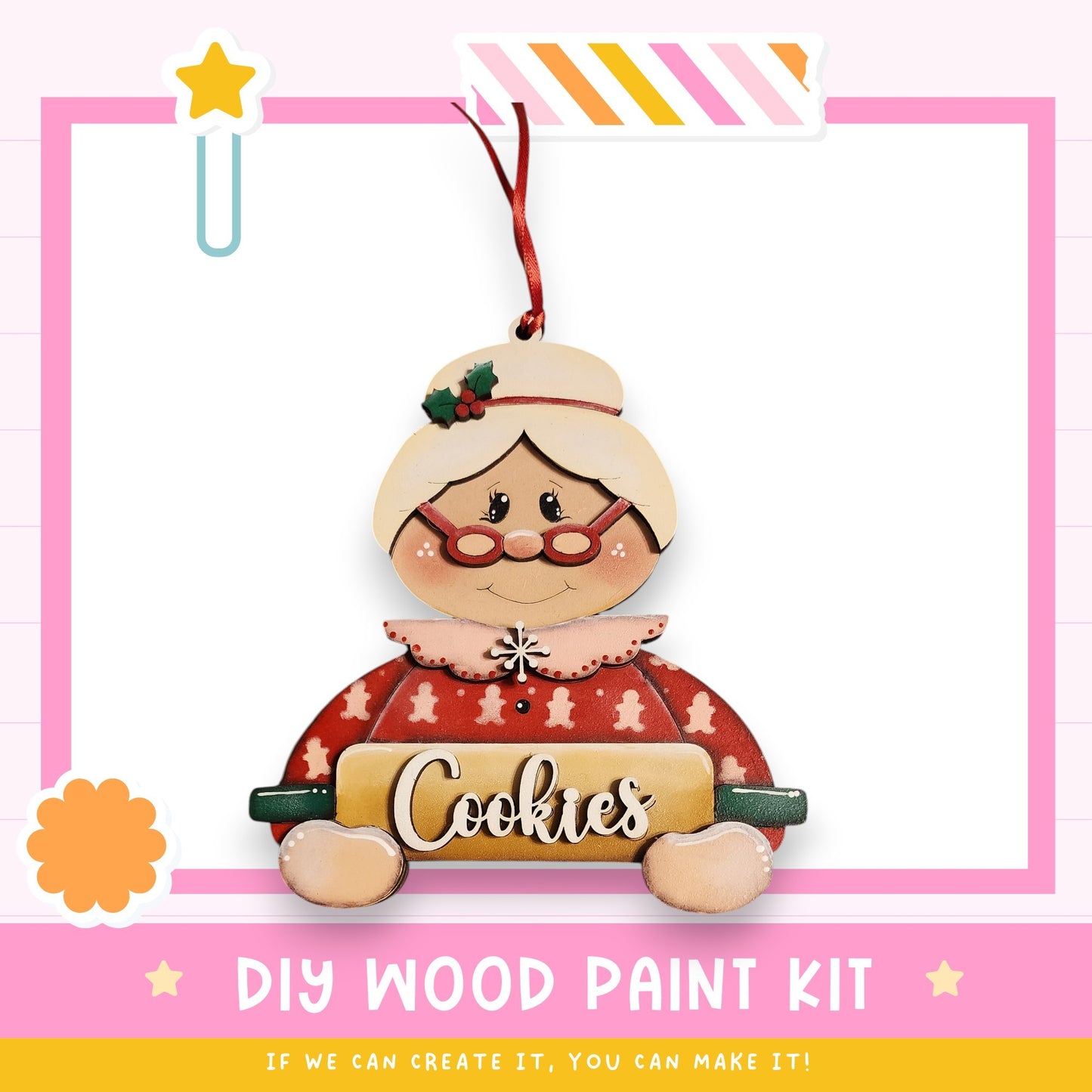 A wooden ornament in the shape of a woman holding a cookie sheet, with the word "Cookies" written on it. The ornament is hanging from a string and is part of a DIY wood paint kit.