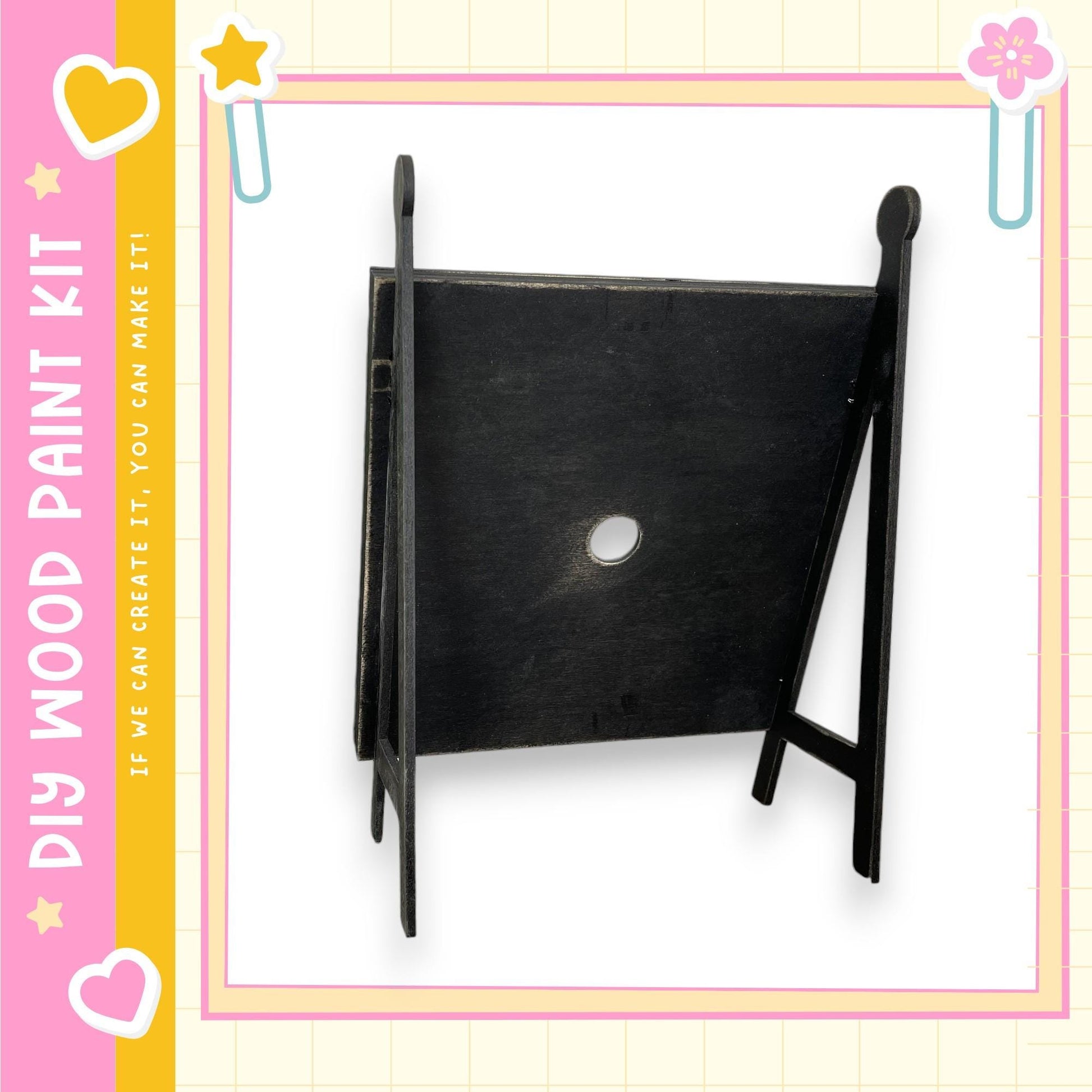 a black wooden frame with a white circular hole in the center.