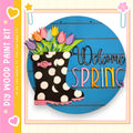 a colorful and whimsical sign that reads "Welcome Spring" with a polka dot boot and a bouquet of flowers as the main decorative elements.