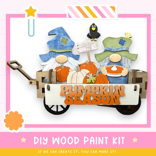 a DIY wood paint kit for creating a pumpkin season decoration, with two gnomes in a wagon holding pumpkins and a sign that says "Pumpkin Season".