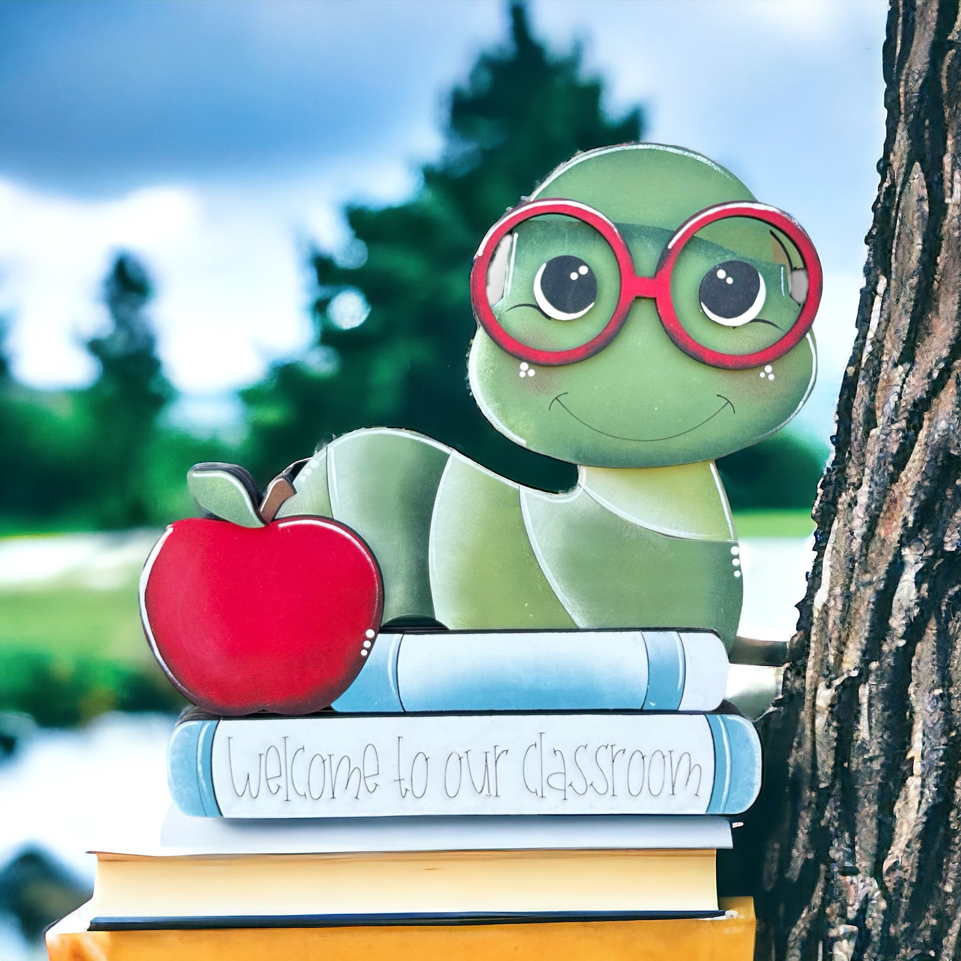 a stuffed turtle is sitting on top of a stack of books