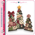 three Christmas tree decorations made of fabric, each with unique patterns and designs. The trees are arranged in a row, creating a festive and decorative display.