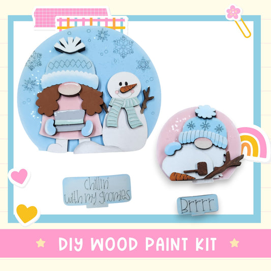 The image is a DIY wood paint kit featuring a snowman and a gnome, with the text "Chilling with my gnomes" and "Brrr" written on it.