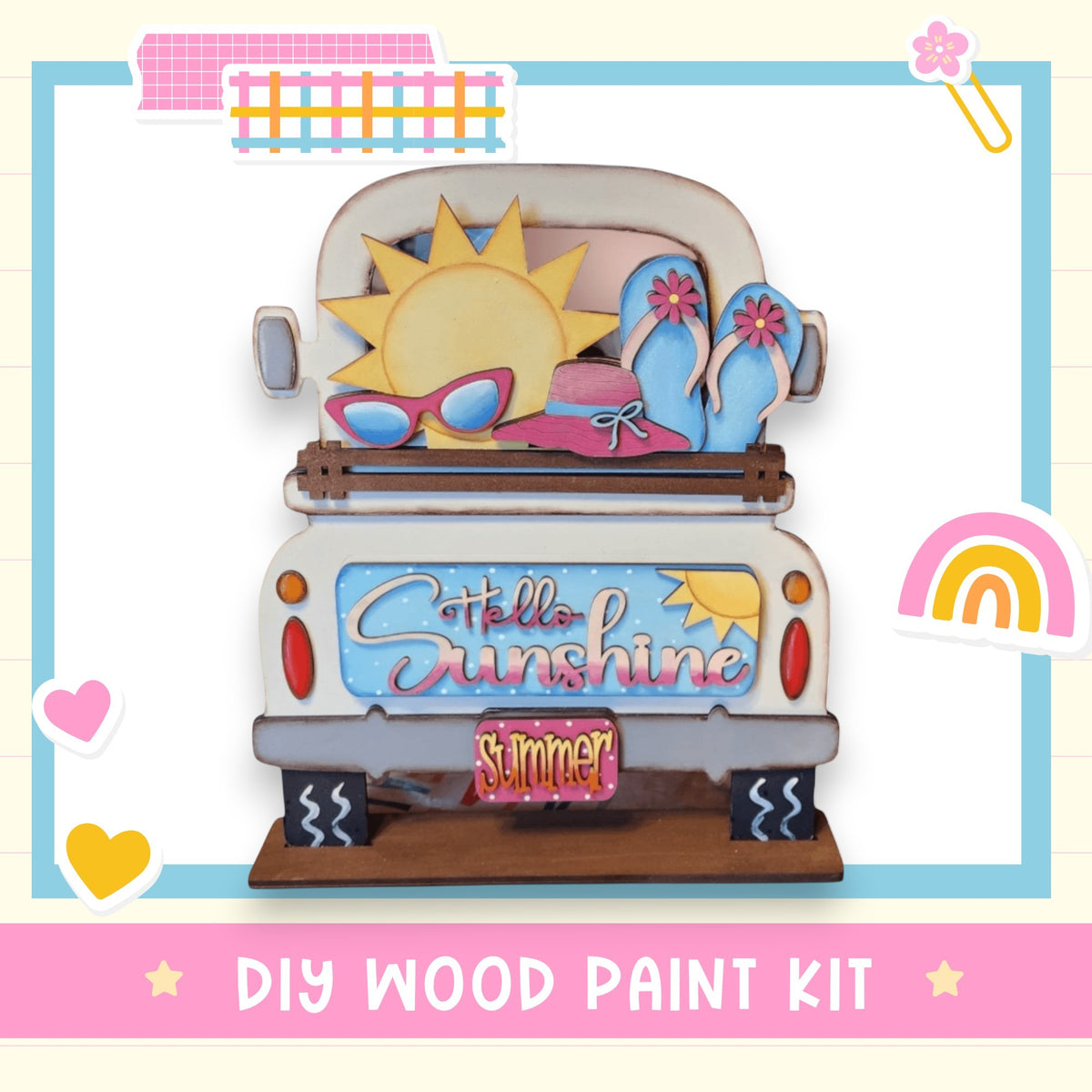 The image is a colorful and whimsical DIY wood paint kit featuring a truck with a sun and sunglasses on the back, a rainbow, and a heart.