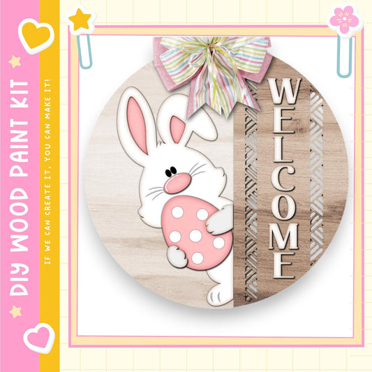 a wooden sign with a cartoon rabbit holding a pink egg, surrounded by decorative elements such as a bow and hearts.