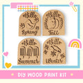 four wooden paint kits labeled with the names of the seasons: "Spring", "Summer", "Autumn", and "Winter".