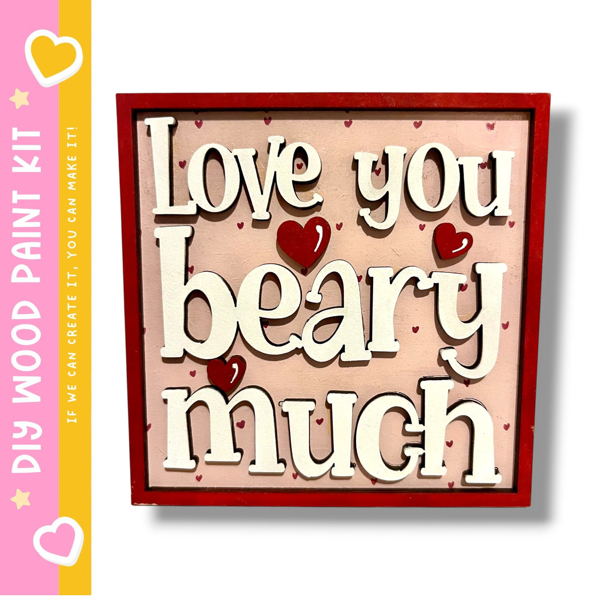 a wooden sign with the text "Love you beary much" in a red frame.