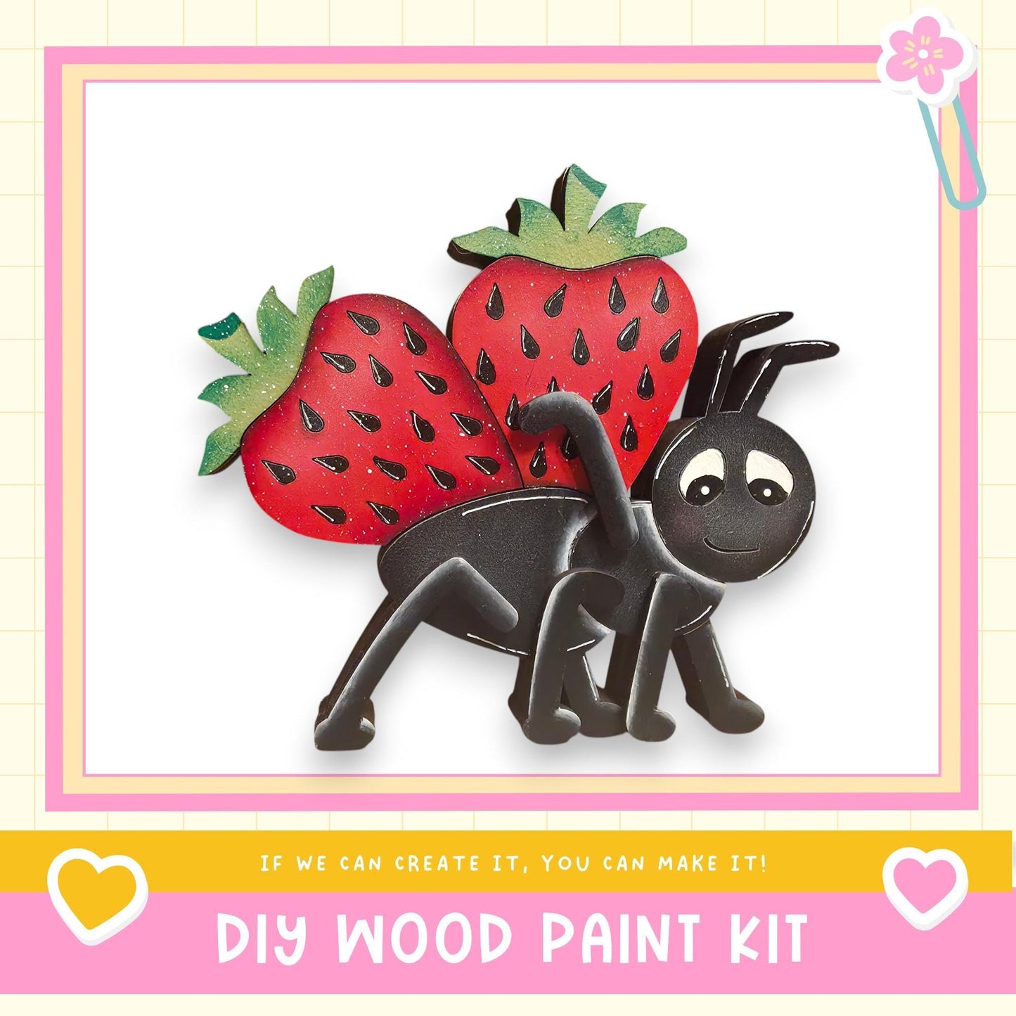 The image is a colorful illustration of a wooden insect, possibly a ladybug, with two large red strawberries on its back. The insect is sitting on a pink background, and there is text at the bottom of the image that reads "DIY WOOD PAINT KIT" and "If we can create it, you can make it!"