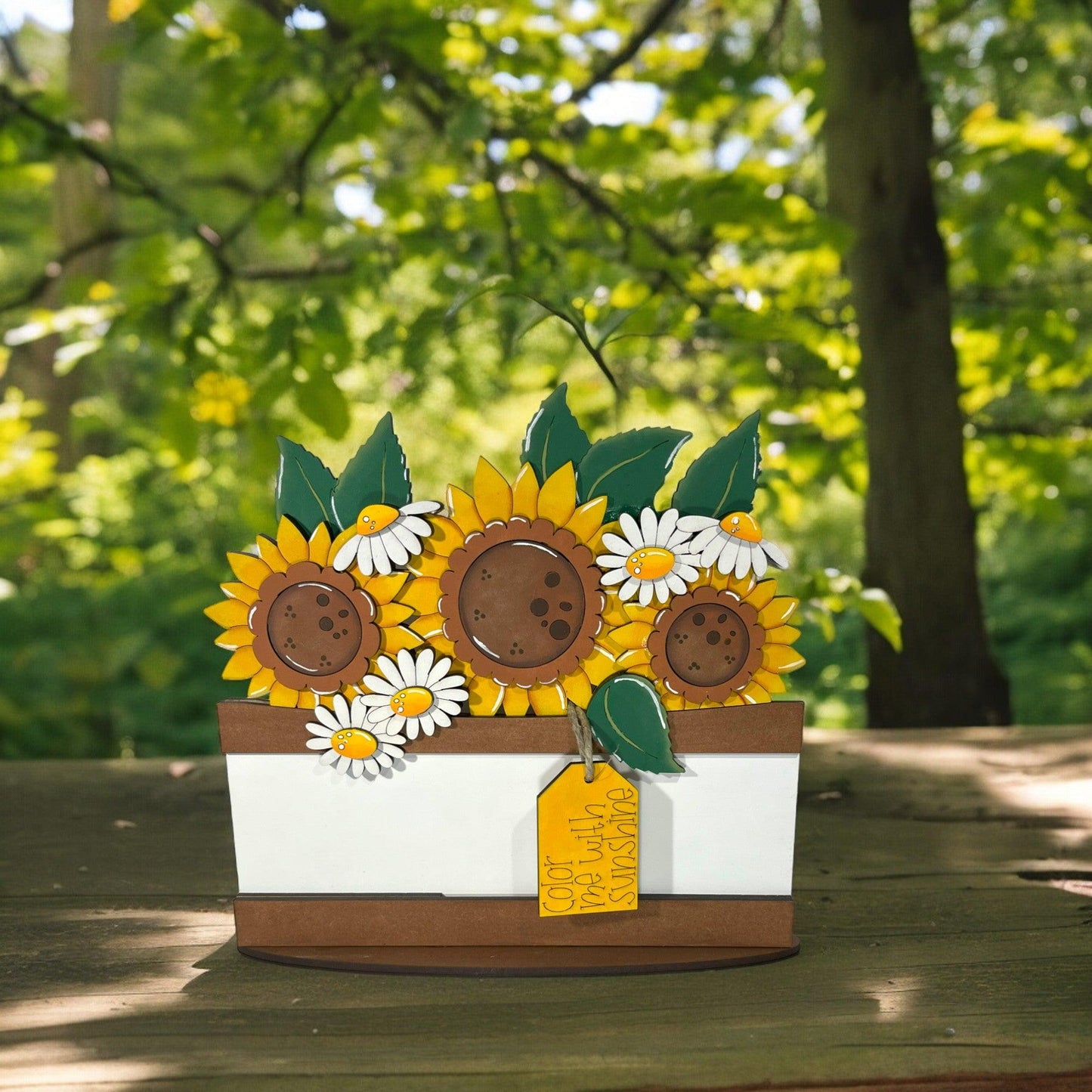 a card with sunflowers in a basket on a table