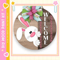 a wooden sign with a cartoon rabbit and the word "WELCOME" written on it.