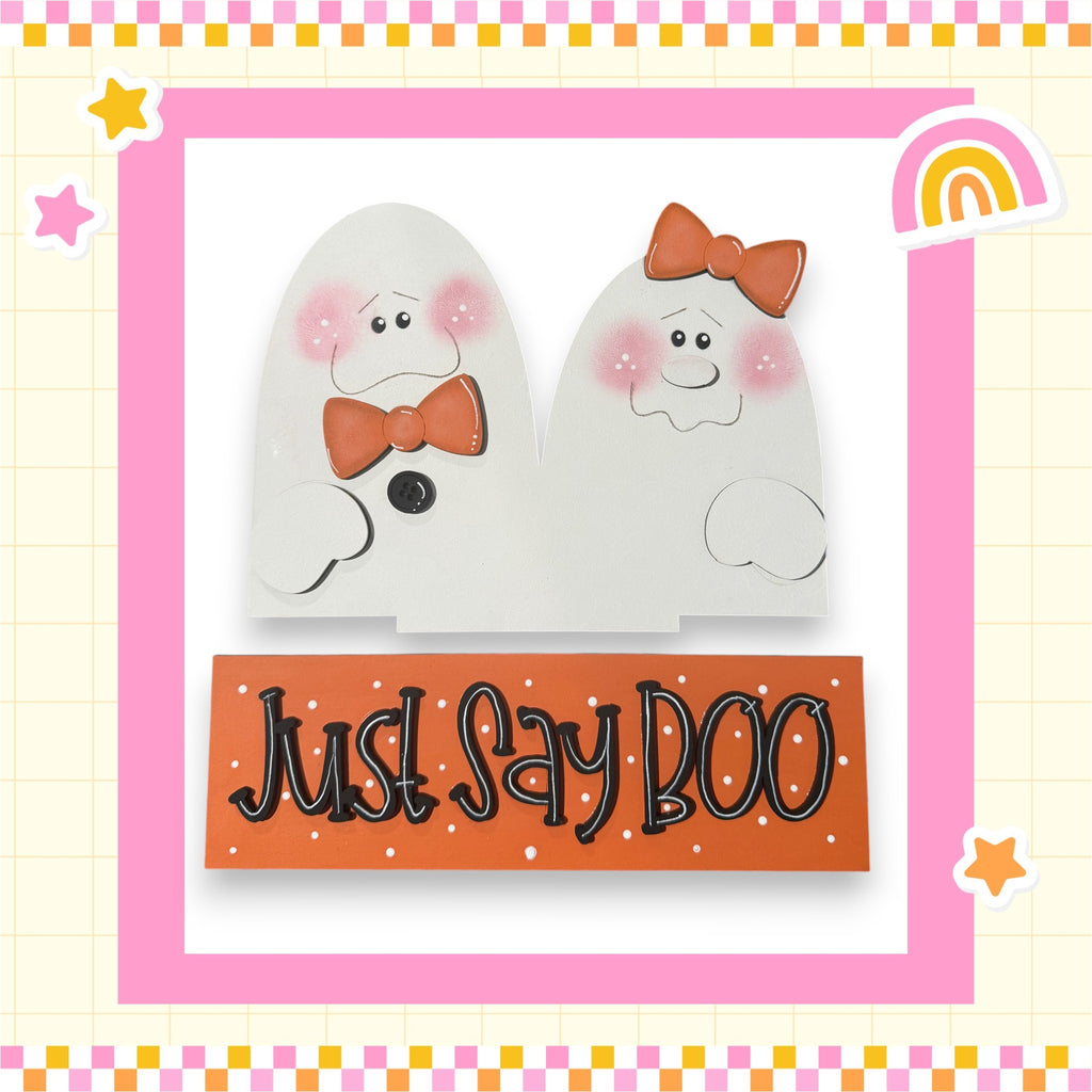 two white ghost characters with orange bows, accompanied by the text "Just Say Boo" in a playful, festive style.