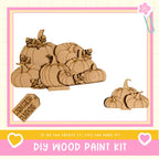 a DIY wood paint kit for creating wooden pumpkins, with a large wooden pumpkin and smaller wooden pumpkins displayed.