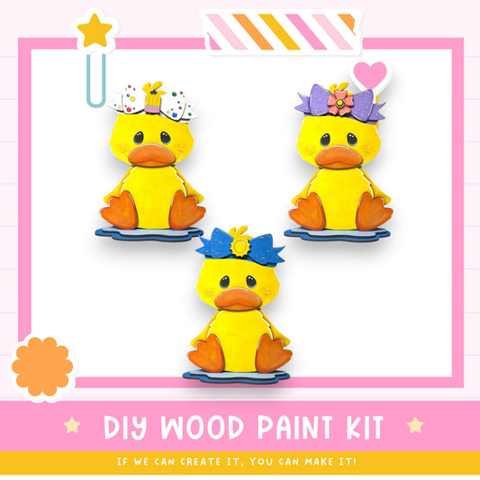 three cheerful yellow duck figures wearing colorful hats, arranged in a row against a pink background.