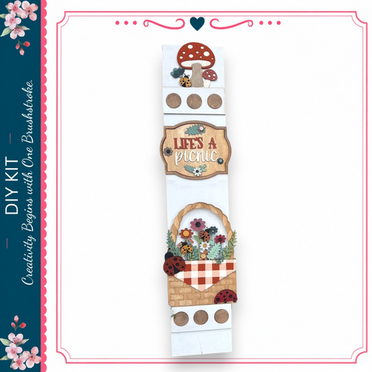 The image is a collage of various decorative elements, including a mushroom, flowers, and a picnic basket, arranged in a vertical format.