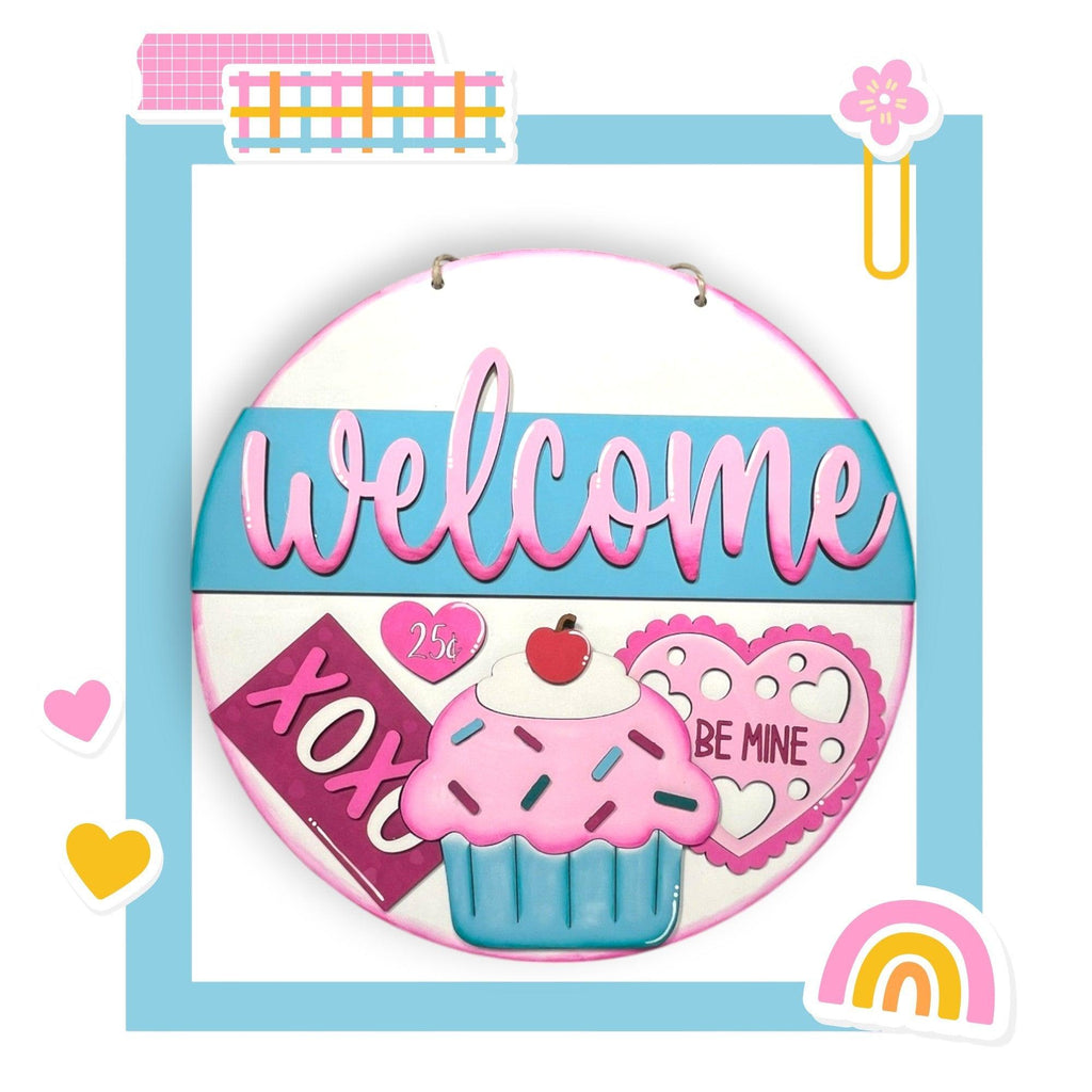 a picture of a welcome sign with a cupcake