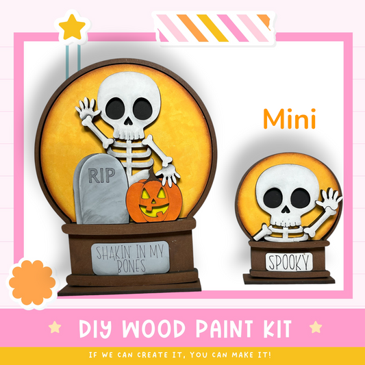The image is a promotional poster for a DIY wood paint kit, featuring a skeleton figurine and a carved pumpkin. The kit is designed for creating a Halloween-themed decoration, such as a carved pumpkin or a spooky centerpiece.
