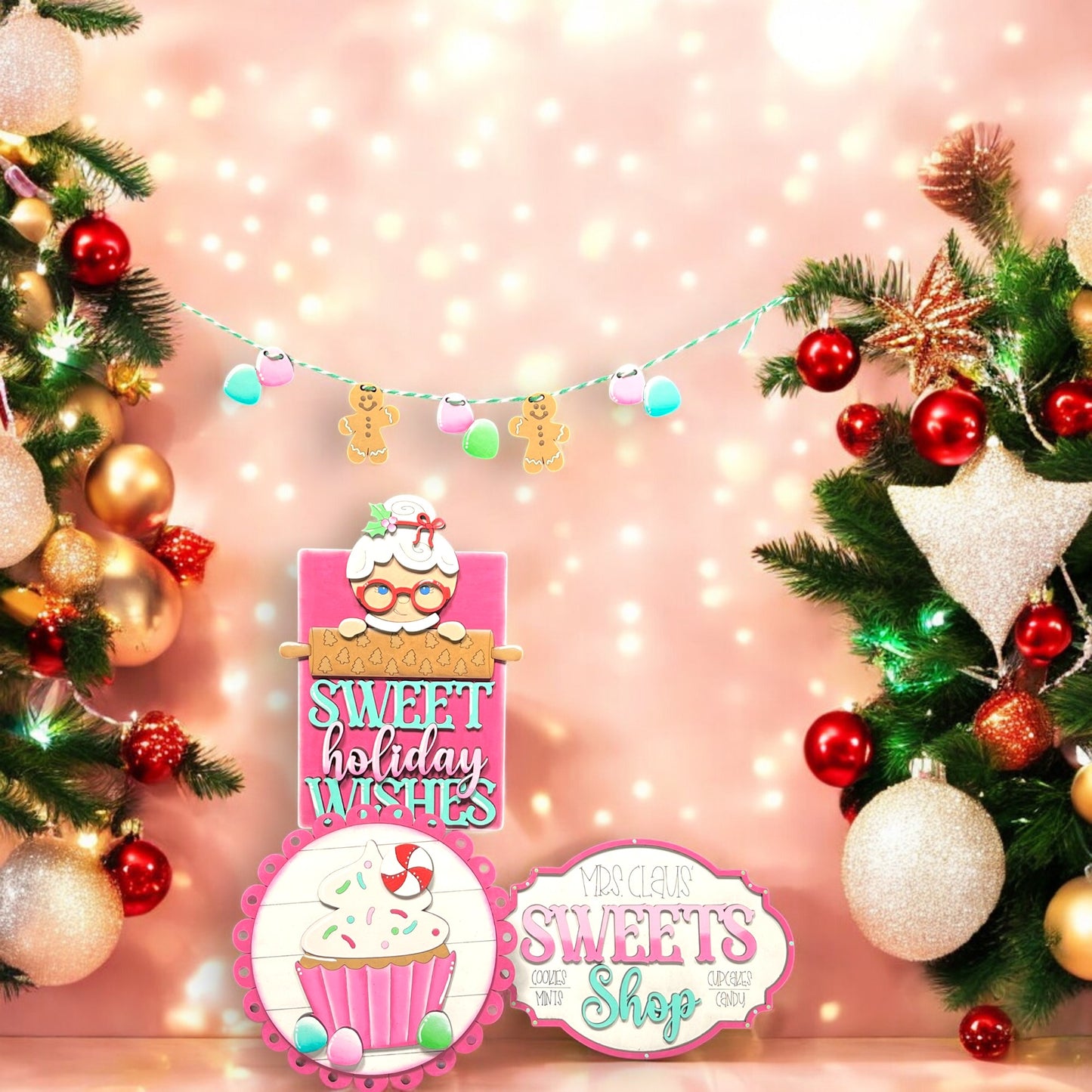 a pink christmas display with cupcakes and decorations