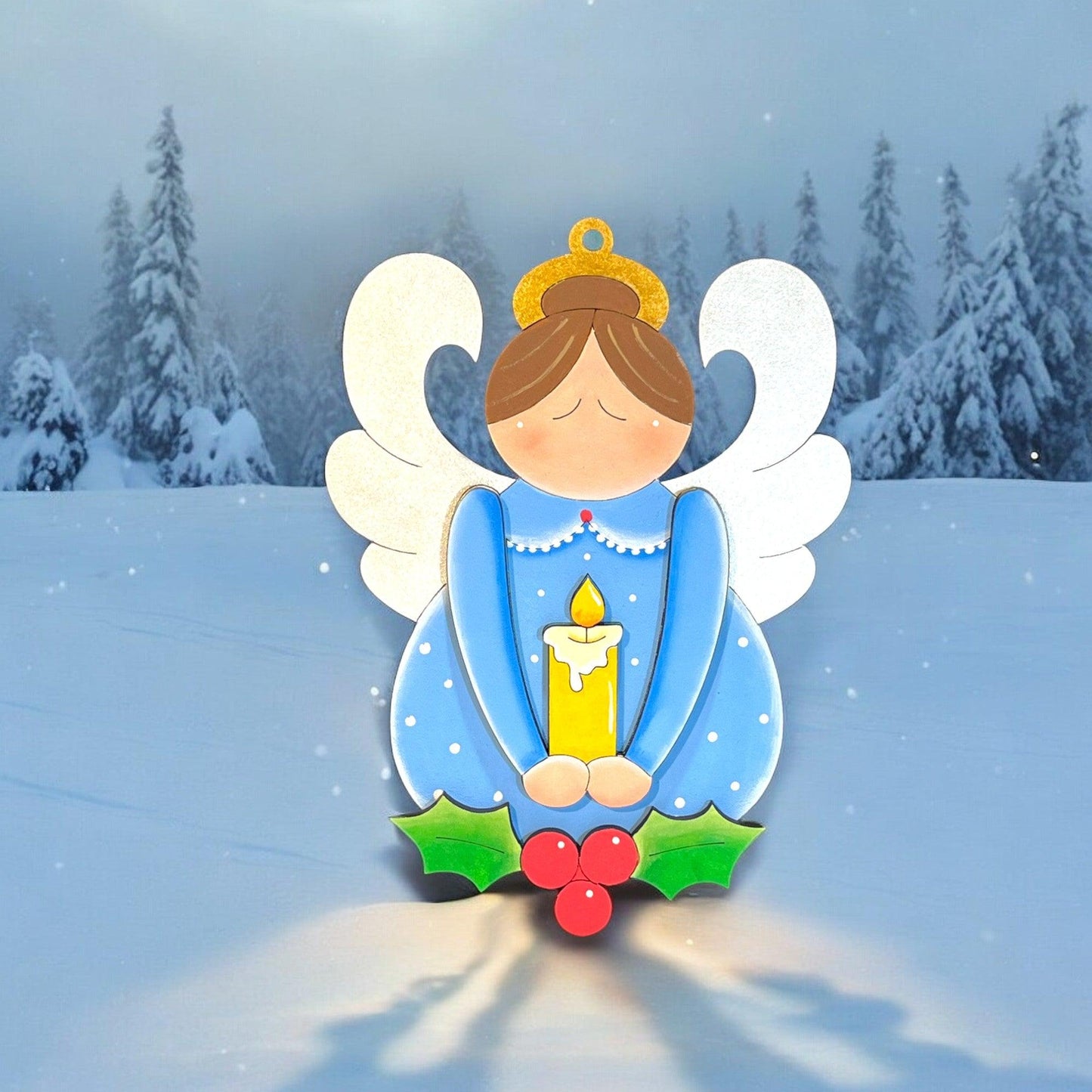 a christmas card with an angel holding a candle