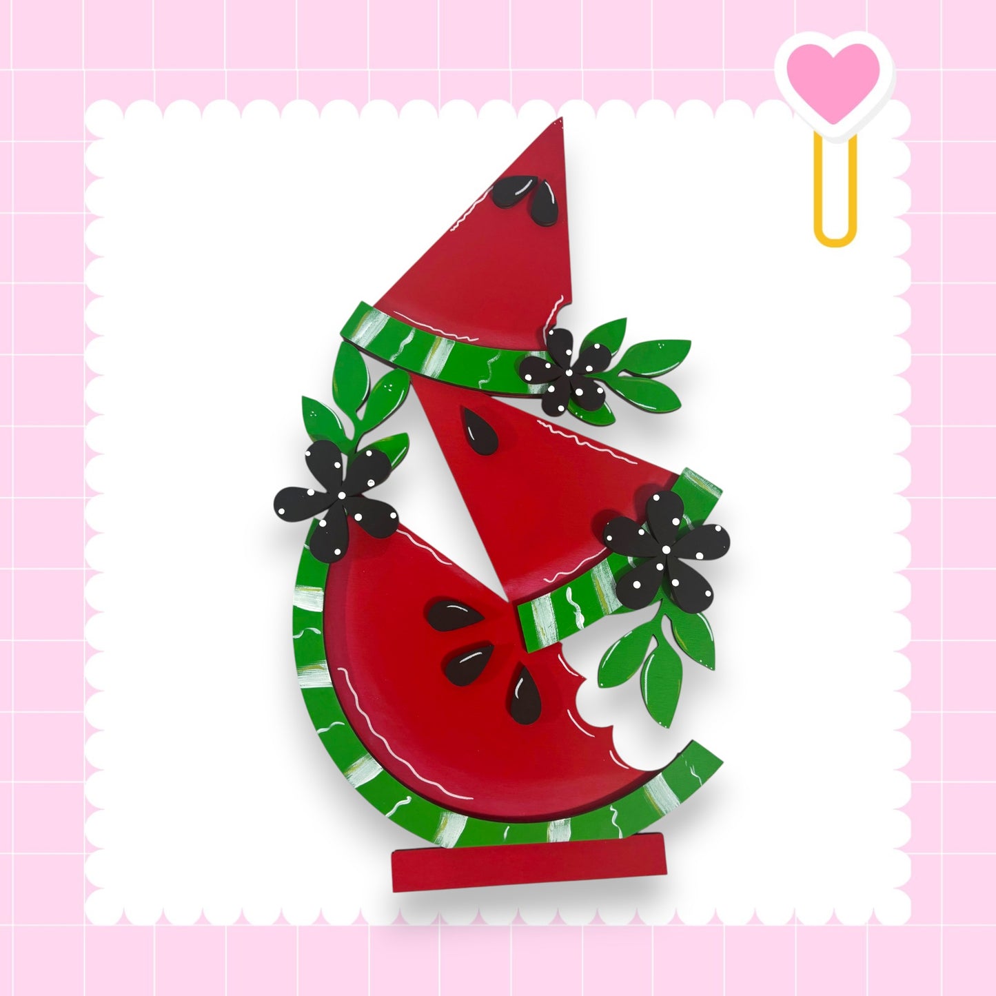 A colorful and whimsical illustration of a watermelon with decorative elements such as leaves and flowers, set against a pink background with a heart shape.