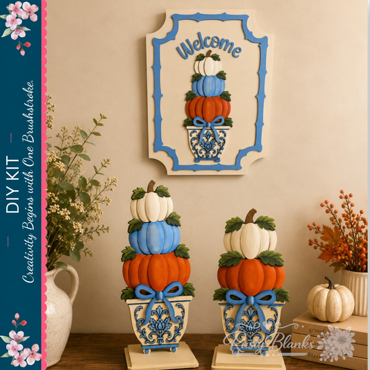 a creative DIY kit for decorating with pumpkins, including a welcome sign and decorative planters. The kit includes pumpkins in various colors, such as orange, white, and blue, as well as decorative elements like ribbons and flowers. The pumpkins are stacked in different sizes and placed in vases, creating a visually appealing display. The kit is set against a backdrop of a wall with a framed picture of pumpkins, adding to the festive atmosphere.