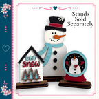 A snowman and a snow globe are displayed on a stand, with the text "Let it snow" and "stands sold separately" written above them.
