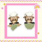 two cartoon cow characters wearing chef hats and holding green bowls, set against a pink and yellow checkered background with stars and a rainbow.